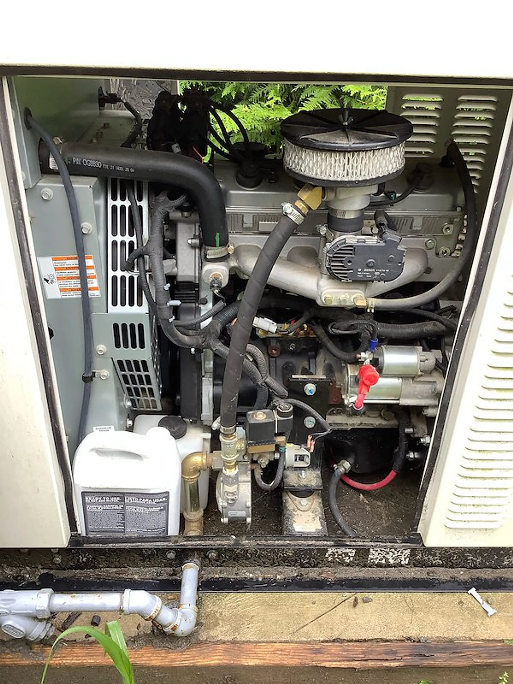 Engine and fuel system inside a standby generator enclosure