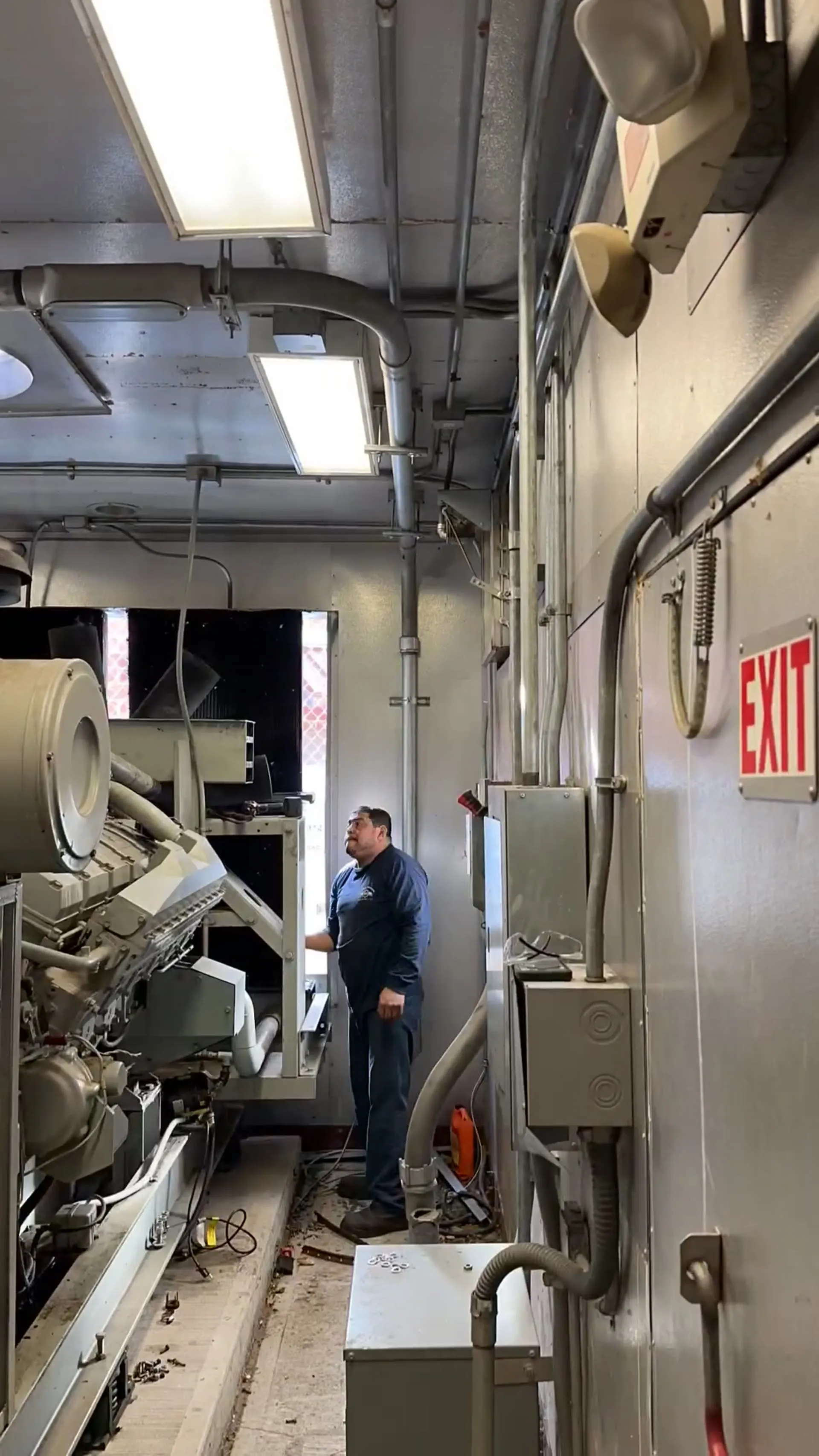 National Standby technician servicing a generator in a plant room