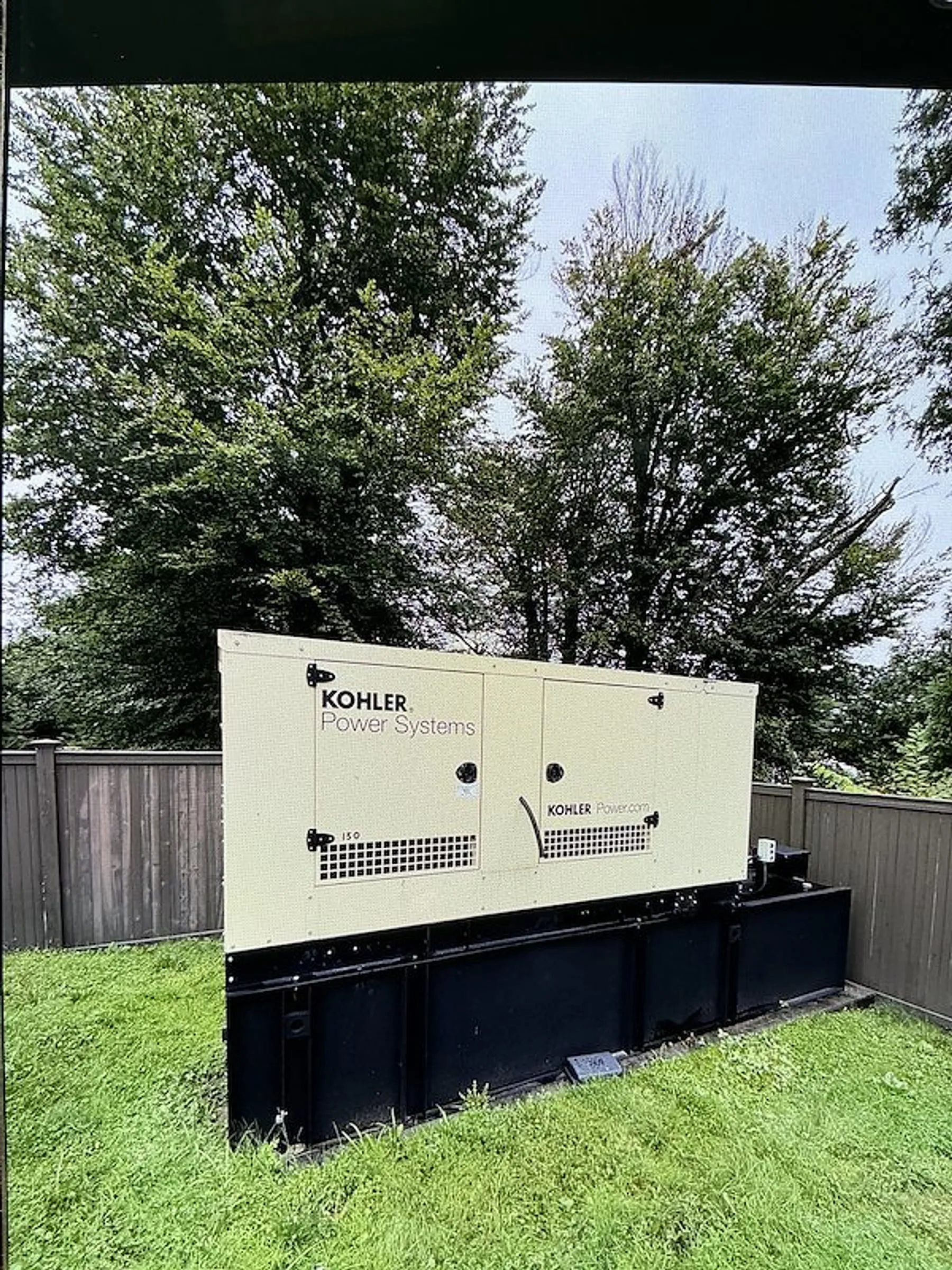 Technician working on a commercial generator control panel
