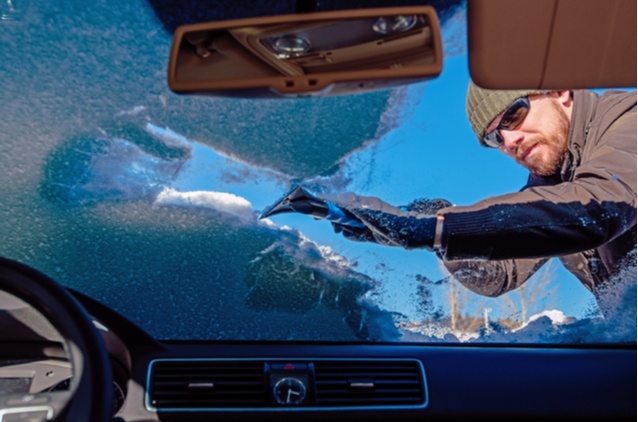emergency winter checklist man clearing snow windshield national standby repair